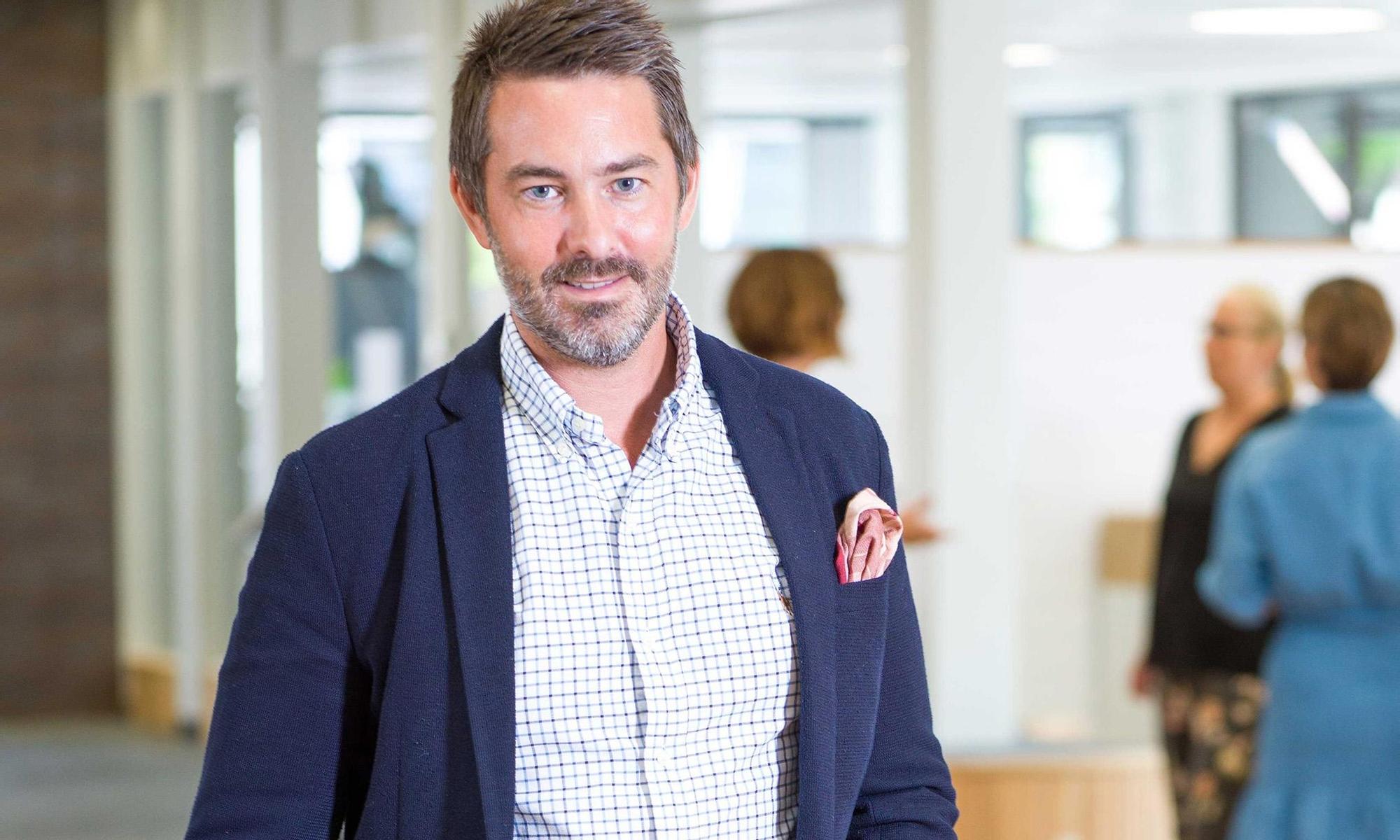 Happy business man in Leksands Sparbanks' foyer