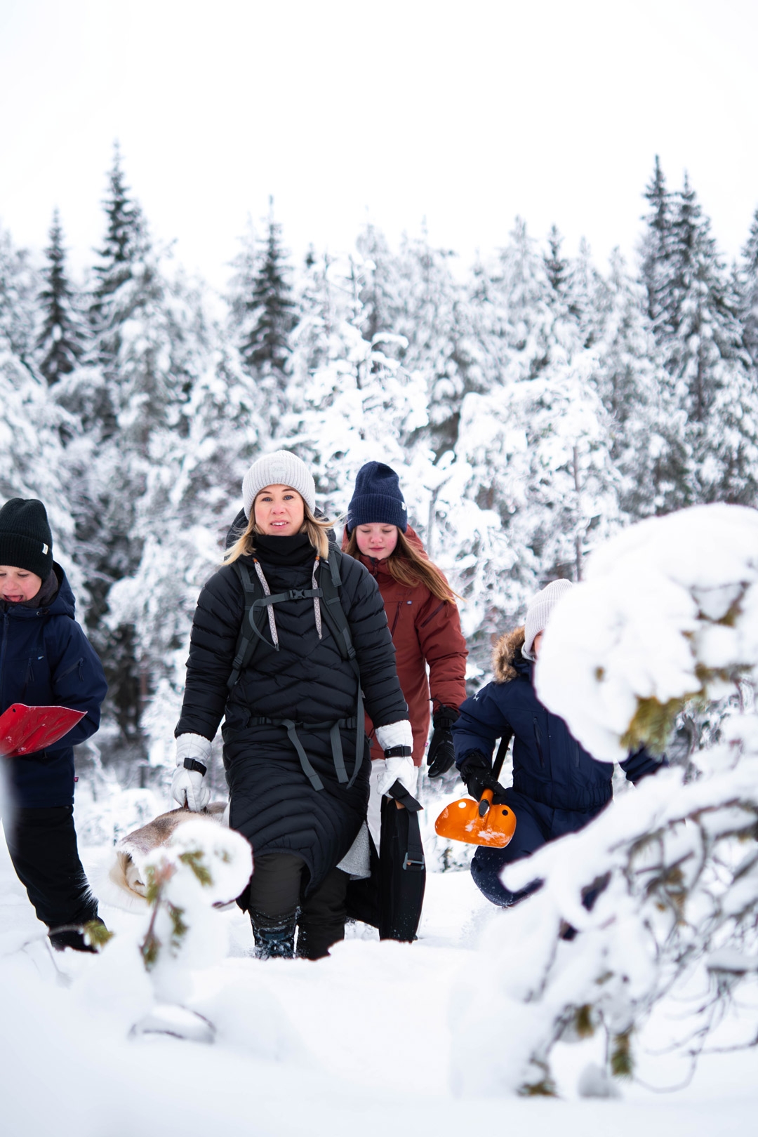 Family in winter forest in Dalarna.